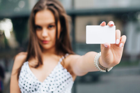 close up woman holding card